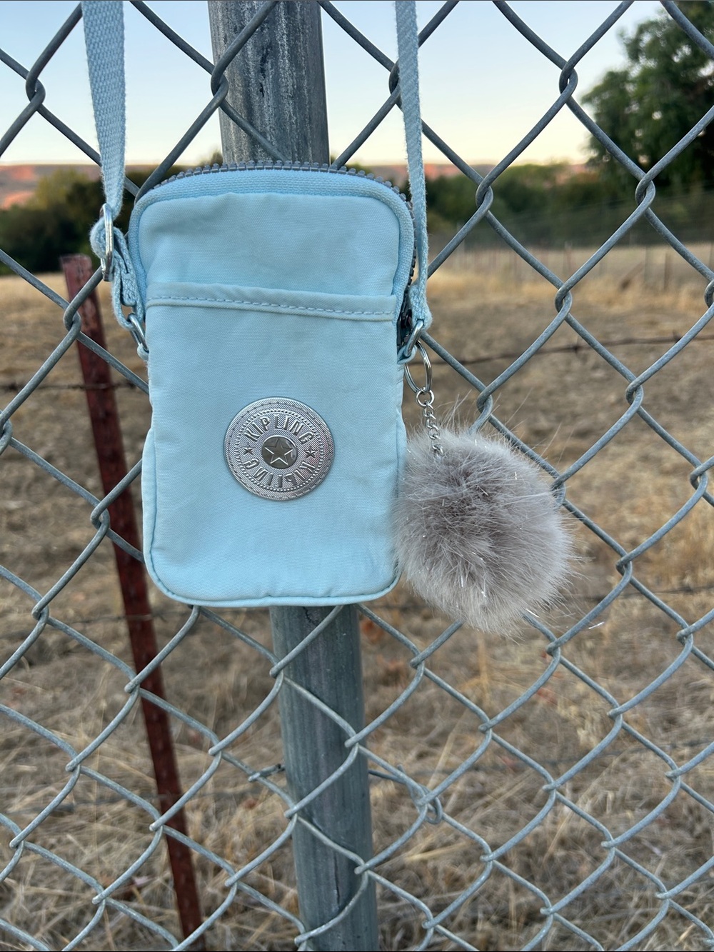 Kipling Powder Blue Crossbody Phone Pouch with Pom Pom